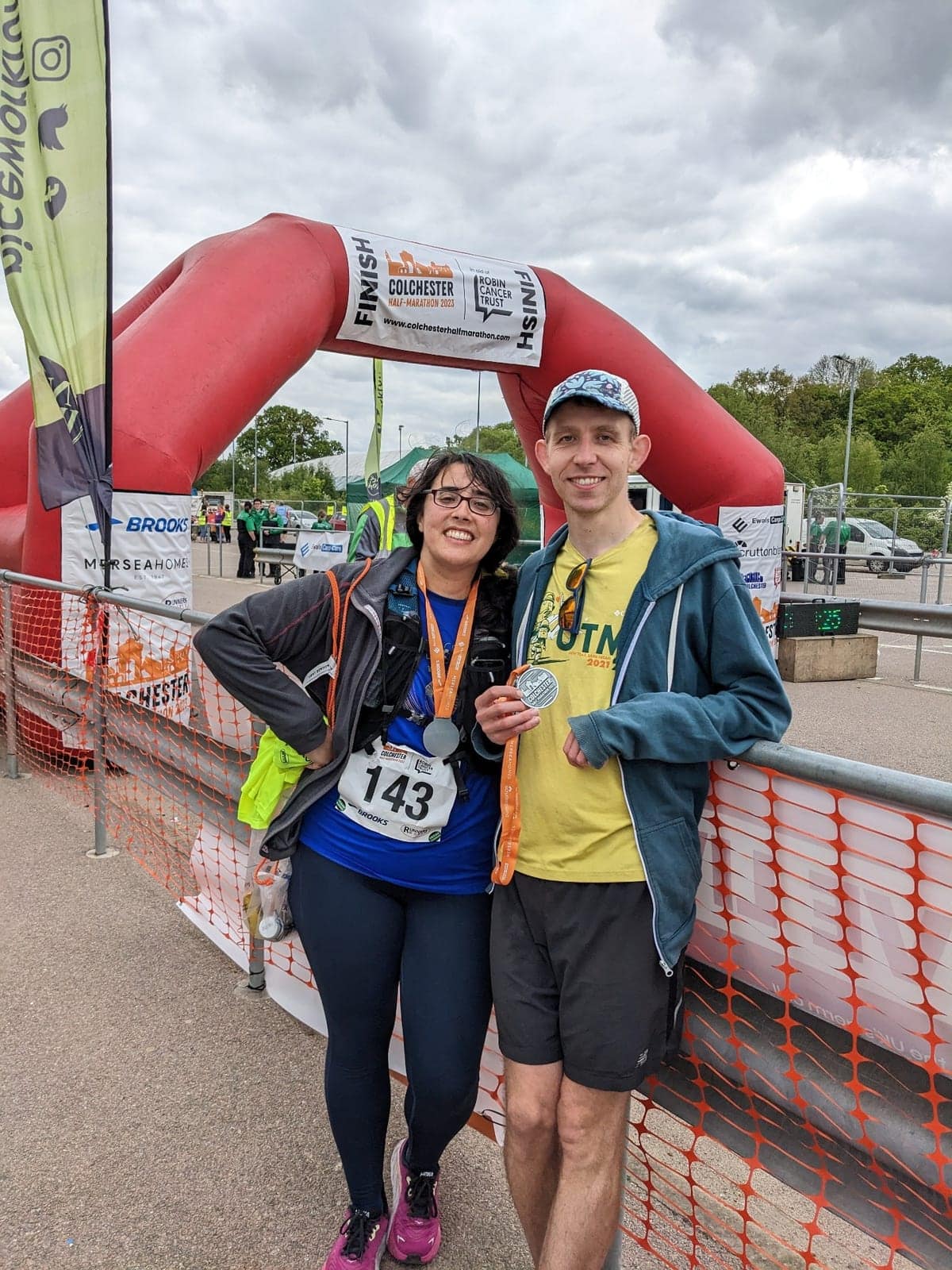Carl and Tara at the Colchester Half Marathon finish line with medals